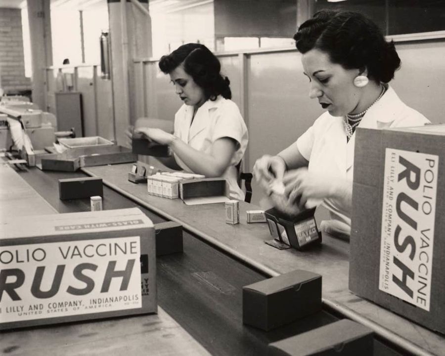 Two women packing cartons stamped Polio Vaccine Rush.